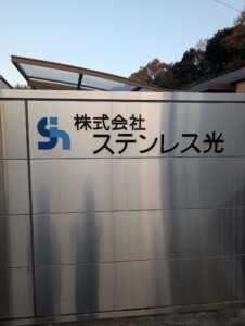 田布施工場門扉正面ロゴ